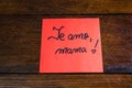 Writing I love you, mom in Spanish te amo, mama on memo post reminder. Text on sticky paper. Mother`s day concept