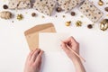 Writing letter to Santa Claus concept. Top above overhead close up first person view photo of female hands holding pen and blank Royalty Free Stock Photo