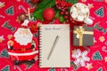 Writing a letter to Santa Claus on a festive red background with Christmas gifts, a plate in the shape of Santa Claus Royalty Free Stock Photo