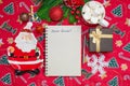 Writing a letter to Santa Claus on a festive red background with Christmas gifts, a plate in the shape of Santa Claus Royalty Free Stock Photo