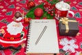 Writing a letter to Santa Claus on a festive red background with Christmas gifts, a plate in the shape of Santa Claus Royalty Free Stock Photo