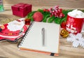 Writing a letter to Santa Claus on a wooden background with Christmas gifts, a plate in the shape of Santa Claus, a mug of marshma Royalty Free Stock Photo