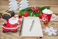 Writing a letter to Santa Claus on a wooden background with Christmas gifts, a plate in the shape of Santa Claus, a mug Royalty Free Stock Photo