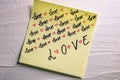 Writing love text on memo post reminder. Sticker with lovely message. Text on notepaper. Valentine`s day concept