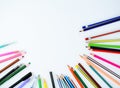 Writing materials randomly scattered on a white background,which includes pens and pencils Royalty Free Stock Photo