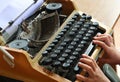 Writing memoirs on an old typewriter - the hands on the keyboard of a typewriter, top view