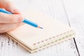 Writing memories note, close up female hand with pen Royalty Free Stock Photo