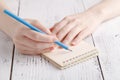 Writing memories note, close up female hand with pen Royalty Free Stock Photo