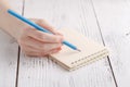 Writing memories note, close up female hand with pen Royalty Free Stock Photo