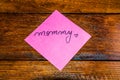 Writing mommy on memo post reminder. Text on sticky paper. Mother`s day concept