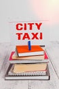 Writing note showing City Taxi. Business photo showcasing type of vehicle for hire with a driver often for a nonshared ride pile Royalty Free Stock Photo