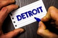 Writing note showing Detroit. Business photo showcasing City in the United States of America Capital of Michigan Motown Man hold
