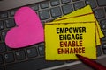Writing note showing Empower Engage Enable Enhance. Business photo showcasing Empowerment Leadership Motivation Engagement Red bor
