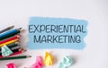Writing note showing Experiential Marketing. The text is written on a small colored paper.desk Royalty Free Stock Photo