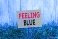 Writing note showing Feeling Blue. Business photo showcasing Feeling of desperation because of sadness or missing Royalty Free Stock Photo
