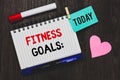 Writing note showing Fitness Goals. Business photo showcasing Loose fat Build muscle Getting stronger Conditioning Open notebook p