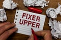 Writing note showing Fixer Upper. Business photo showcasing house in need of repairs used chiefly connection with purchase Man hol Royalty Free Stock Photo