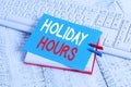 Writing note showing Holiday Hours. Business photo showcasing employee receives twice their normal pay for all hours Royalty Free Stock Photo