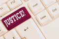 Writing note showing Justice. Business photo showcasing impartial adjustment of conflicting claims or assignments White Royalty Free Stock Photo