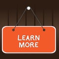 Writing note showing Learn More. Business photo showcasing knowledge or skill acquired by instruction Considerable Royalty Free Stock Photo