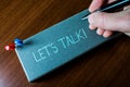 Writing note showing Let S Talk. Business photo showcasing they are suggesting beginning conversation on specific topic Royalty Free Stock Photo