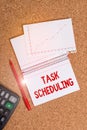 Writing note showing Task Scheduling. Business photo showcasing The assignment of start and end times to a set of tasks Desk