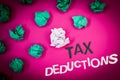 Writing note showing Tax Deductions. Business photo showcasing Reduction on taxes Investment Savings Money Returns Text Words pin