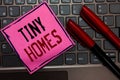 Writing note showing Tiny Homes. Business photo showcasing houses contain one room only or two and small entrance Cheap Pink paper