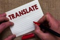 Writing note showing Translate. Business photo showcasing Another word with same equivalent meaning of a target language Man's ha Royalty Free Stock Photo