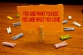 Writing note showing You Are What You Eat. You Are What You Love.. Business photo showcasing Start to eat healthy food Paperclip