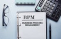 The writing on the notebook has business or marketing content. Top view of work desk, business accessories, calculator. Finance or Royalty Free Stock Photo