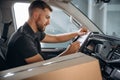 Writing in the notepad document. The delivery man or a loader is in the car with box Royalty Free Stock Photo