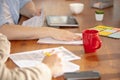 Hands of colleagues working together in a office using modern devices and gadgets during creative meeting. Close up. Royalty Free Stock Photo