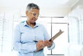 Writing, optometrist or mature manager with glasses checklist for store inventory or eyewear choice. Woman, product info