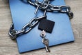 a writing pad wrapped in an iron chain with an open lock with keys information protection concept data protection Royalty Free Stock Photo