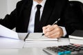 Writing paper on desk, businessman hand using calculator Calculating bonusOr other compensation to employees to increase Royalty Free Stock Photo