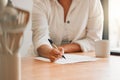 Writing, paperwork and contract with a woman holding a pen and filling out an application form in her kitchen at home Royalty Free Stock Photo