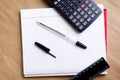 Writing pen. Office to work in the office. School supplies. Pens, pencils, ruler, calculator and a clean notebook. White list Royalty Free Stock Photo