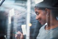 Writing, planning strategy and brainstorming ideas on a glass wall in a modern design office. Young business woman Royalty Free Stock Photo