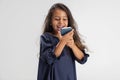 Portrait of one cute Caucasian preschool girl in beautiful blue dress with smartphone isolated over white studio Royalty Free Stock Photo
