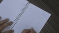 Writing Sorry on open notebook. Closeup. Mistake learning, blooper, regret sayings in love relationship friendship background.