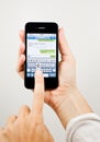 Writing a text message on iPhone 4 Royalty Free Stock Photo