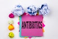 Writing text showing Antibiotics written on sticky note in office with paper balls. Business concept for Health care Prescri