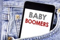 Writing text showing Baby Boomers. Business concept for Demographic Generation written on cellphone phone smartphone in the men po Royalty Free Stock Photo