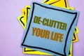 Writing text showing De-Clutter Your Life. Business photo showcasing Free Less Chaos Fresh Clean Routine written on sticky note p Royalty Free Stock Photo