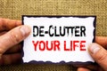 Writing text showing De-Clutter Your Life. Concept meaning Free Less Chaos Fresh Clean Routine written on Sticky Note Paper Holdi Royalty Free Stock Photo