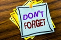Writing text showing Do Not Forget. Business concept for Don t memory Remider written on sticky note paper on the wooden backgroun Royalty Free Stock Photo