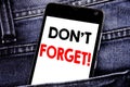 Writing text showing Do Not Forget. Business concept for Reminder Message written mobile cell phone with copy space in the back pa Royalty Free Stock Photo