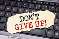 Writing text showing Don t Give Up. Business concept for Motivation Determination, written on sticky note paper on the black keybo