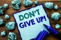 Writing text showing Don t Give Up. Business concept for Motivation Determination, Written on sticky note paper, wooden background